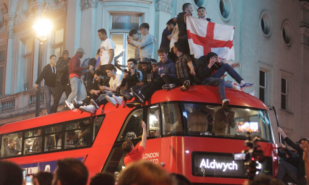 England Fans pictured in Piccadilly and Haymarket jumping on the famous red double-decker bus celebrating after their team reached the Euro's 2020 final beating Denmark 2-1 at Wembley stadium.