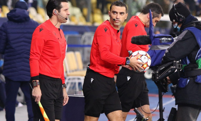 KYIV, UKRAINE - NOVEMBER 2, 2021: Referee Ovidiu Hategan (ROU) and assistants Mircea Mihail Grigoriu and Sebastian Gheorghe go to the pitch before UEFA Champions League game Dynamo Kyiv v Barcelona