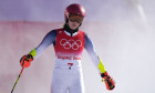 Mikaela Shiffrin of the U.S. emerges from a cloud of snow after crashing out of the course