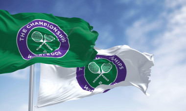 London, UK, April 2022: flags with the The Championships Wimbledon logo waving in the wind. Wimbledon Championships is a major tennis tournament sched