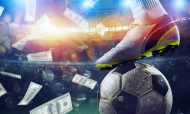 Soccer player in stadium with falling banknotes of bettors
