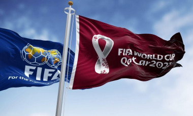 Doha, Qatar, January 2022: Flags with FIFA and Qatar 2022 World Cup logo waving in the wind. The event is scheduled in Qatar from 21 November to 18 De