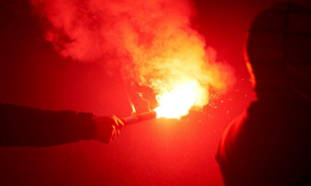 flaming red flare during a street protest in the city