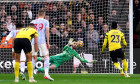 Manchester United goalkeeper David de Gea makes a save from Watford's Ismaila Sarr retaken penalty kick during the Premier League match at Vicarage Road, Watford. Picture date: Saturday November 20, 2021.