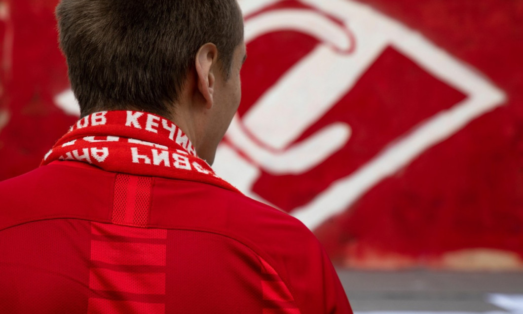 Football club Spartak fan on the background of the club emblem in Moscow, Russia