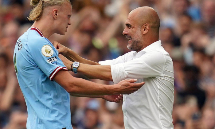 Manchester City's Erling Haaland celebrates scoring his side fourth goal of the game to complete his hat trick with manager Pep Guardiola during the Premier League match at the Etihad Stadium, Manchester. Picture date: Saturday August 27, 2022.