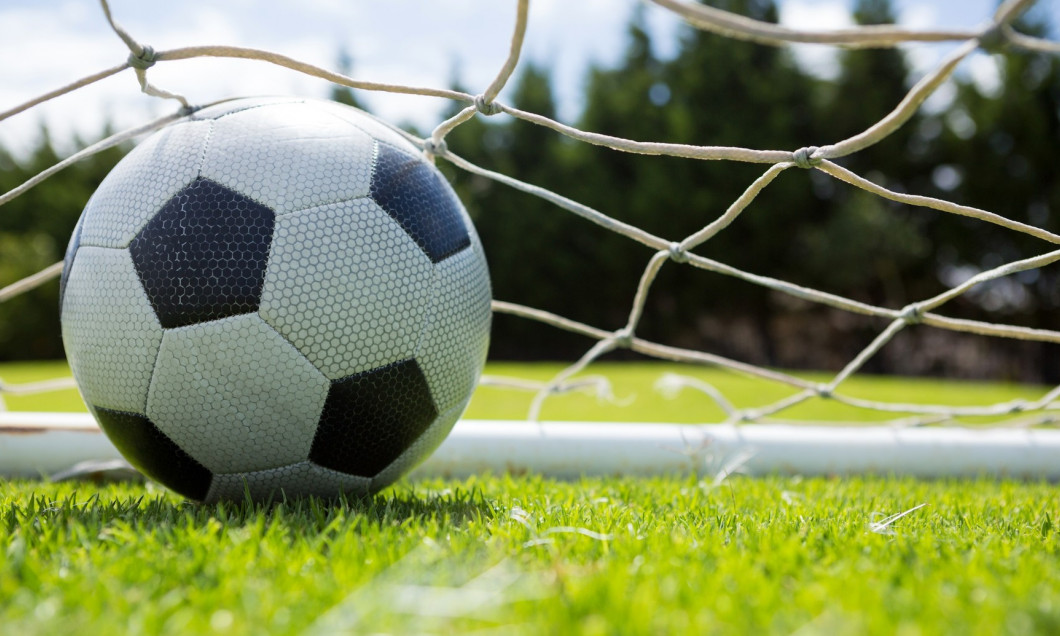 Close up of soccer ball in goal post