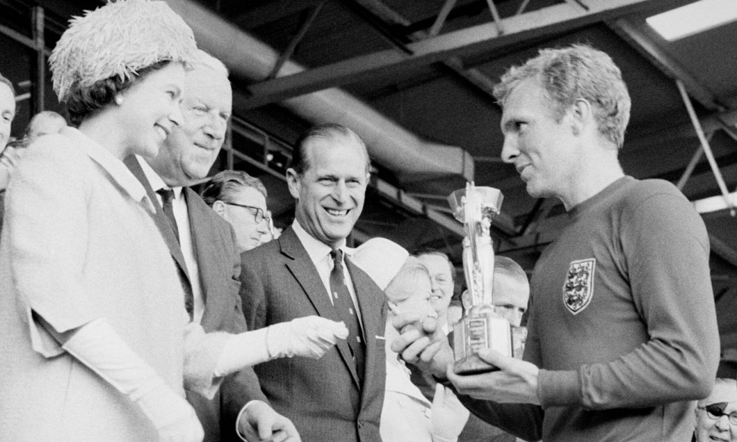 File photo dated 30/07/1966 of England captain Bobby Moore holds the Jules Rimet Trophy, collected from the Queen Elizabeth II, after leading his team to a 4-2 victory over West Germany, in an exciting World Cup Final that went to extra time at Wembley, L