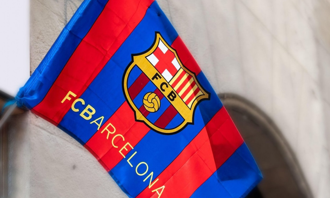 Low angle view of a Football Club Barcelona or FCB. The textile symbol is waving in the wind in the door of a private small souvenir store