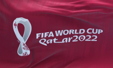 Doha, Qatar, October 2021: Flag with the 2022 Fifa World Cup logo flapping in the wind. The event is scheduled in Qatar from 21 November to 18 Decembe