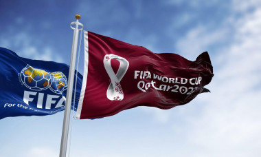 Doha, Qatar, January 2022: Flags with FIFA and Qatar 2022 World Cup logo waving in the wind. The event is scheduled in Qatar from 21 November to 18 De