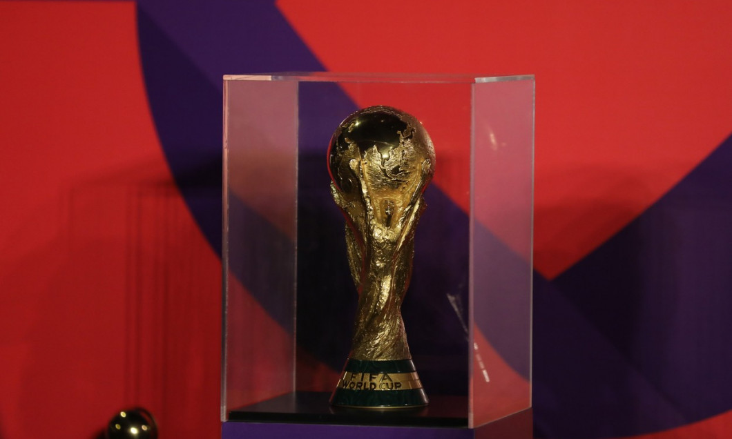 Football fans take photo with original version of World trophy during the FIFA World Cup Qatar 2022 on the Doha Corniche, in Qatar, Doha, Qatar - 15 Dec 2022