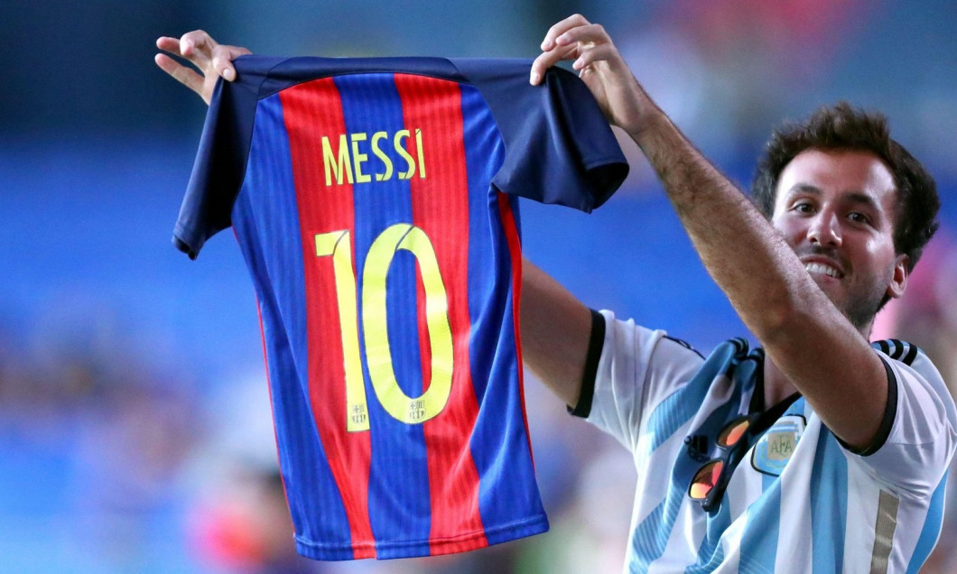 Barcelona fan shows Messi's shirt during the Joan Gamper Trophy match between Fc Barcelona and Juventus Fc . Fc Barcelona wins 3-0 over Juventus Fc.