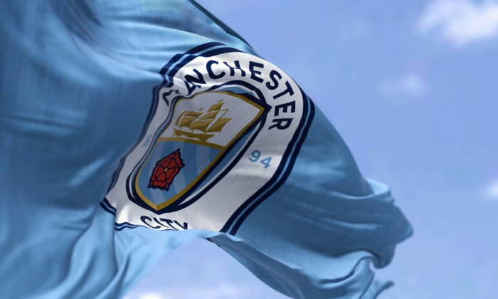 Manchester, UK, May 2022: The flag of Manchester City Football Club waving in the wind on a clear day. Manchester F.C. is a professional football club