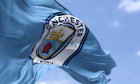 Manchester, UK, May 2022: The flag of Manchester City Football Club waving in the wind on a clear day. Manchester F.C. is a professional football club