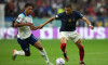 England's Jude Bellingham (left) and France's Kylian Mbappe battle for the ball during the FIFA World Cup Quarter-Final match at the Al Bayt Stadium in Al Khor, Qatar. Picture date: Saturday December 10, 2022.