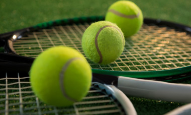 Close up of tennis balls with rackets
