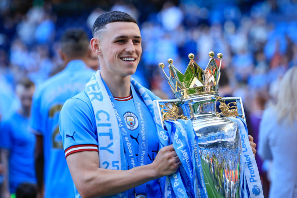 Premier League Manchester City vs Chelsea Phil Foden 47 of Manchester City with the Premier League trophy after the Prem