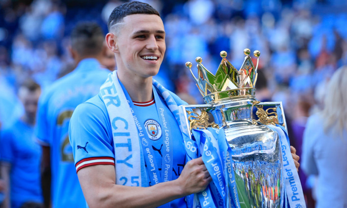 Premier League Manchester City vs Chelsea Phil Foden 47 of Manchester City with the Premier League trophy after the Prem