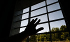 Ravensbureg, Germany. 26th May, 2023. The new building of Ravensburg Prison is completed. A man holds his hand to the window in a single cell. The prisoners are due to start moving in in July. Credit: Felix Kstle/dpa/Alamy Live News