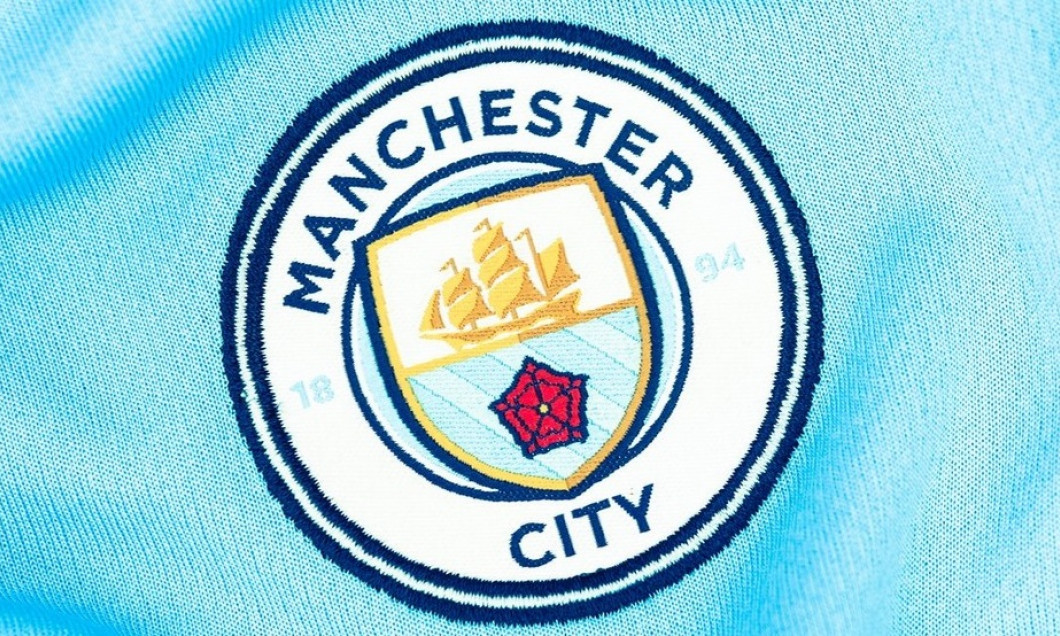 Close up of MCFC Jersey. MCFC Crest.