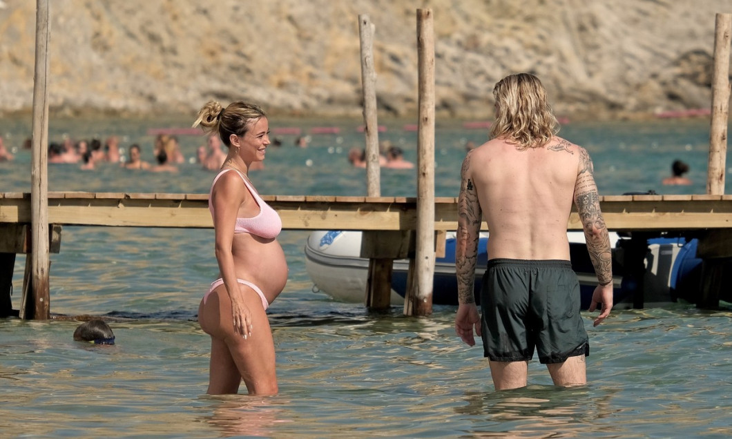 The Italian sports presenter Diletta Leotta showcases her ever-growing baby bump spotted out on the beaches of Ibiza with her beau, the Newcastle goalkeeper Loris Karius.