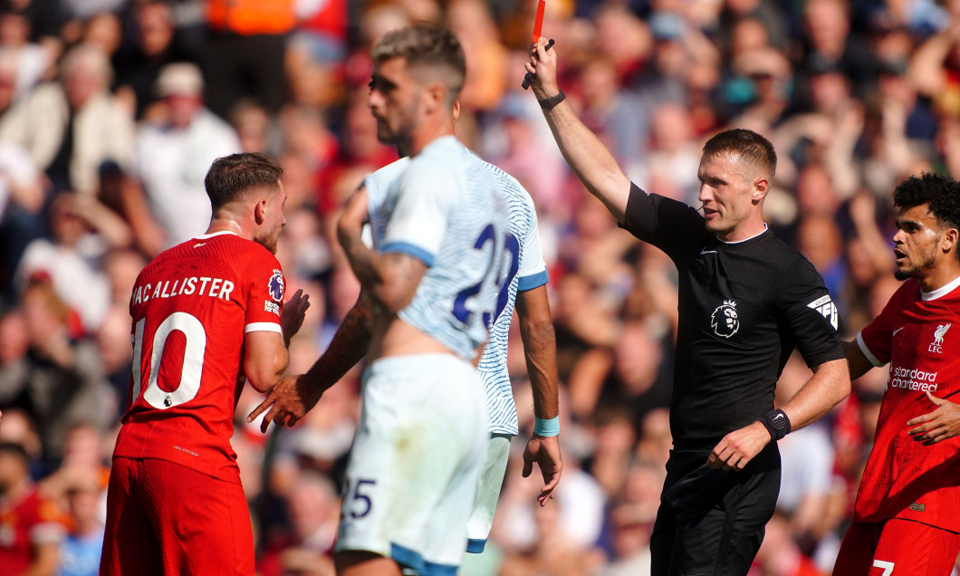 Referee Thomas Bramall shows a red card to Liverpool's Alexis Mac Allister for serious foul play during the Premier League match at Anfield, Liverpool. Picture date: Saturday August 19, 2023.