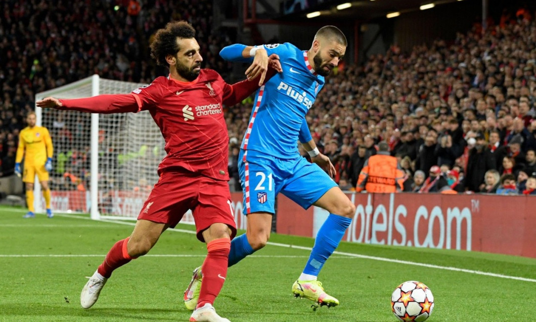 Mohamed Salah #11 of Liverpool challenges Yannick Carrasco #21 of Atletico Madrid for the ball