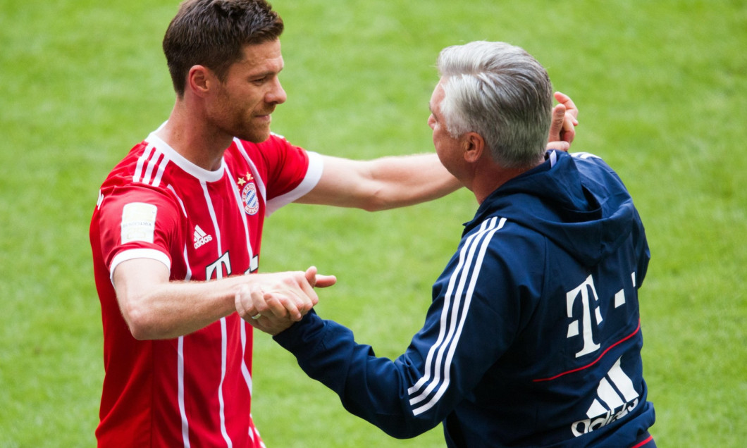 Munich's Xabi Alonso (L) and manager Carlo Ancelotti hug at the end of the German Bundesliga soccer match between Bayern Munich and SC Freiburg in the Allianz Arena in Munich, Germany, 20 May 2017. (EMBARGO CONDITIONS - ATTENTION: Due to the accreditat