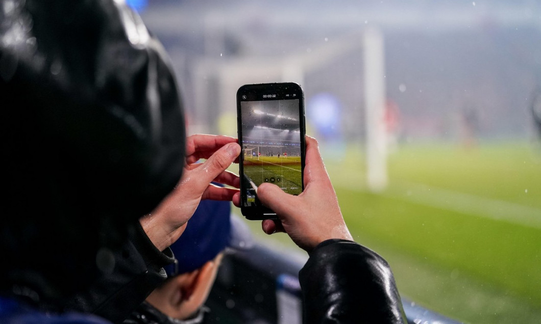 Eindhoven, Netherlands. 08th Nov, 2023. EINDHOVEN, NETHERLANDS - NOVEMBER 8: A Fan taking a video or photo with his phone during the UEFA Champions League Group B match between PSV and RC Lens at Philips Stadion on November 8, 2023 in Eindhoven, Netherlan