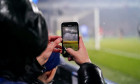 Eindhoven, Netherlands. 08th Nov, 2023. EINDHOVEN, NETHERLANDS - NOVEMBER 8: A Fan taking a video or photo with his phone during the UEFA Champions League Group B match between PSV and RC Lens at Philips Stadion on November 8, 2023 in Eindhoven, Netherlan