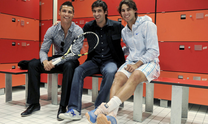 Real Madrid players Ronaldo and Gonzalez pose with tennis player Nadal inside the dressing room during the Madrid Open tennis tournament
