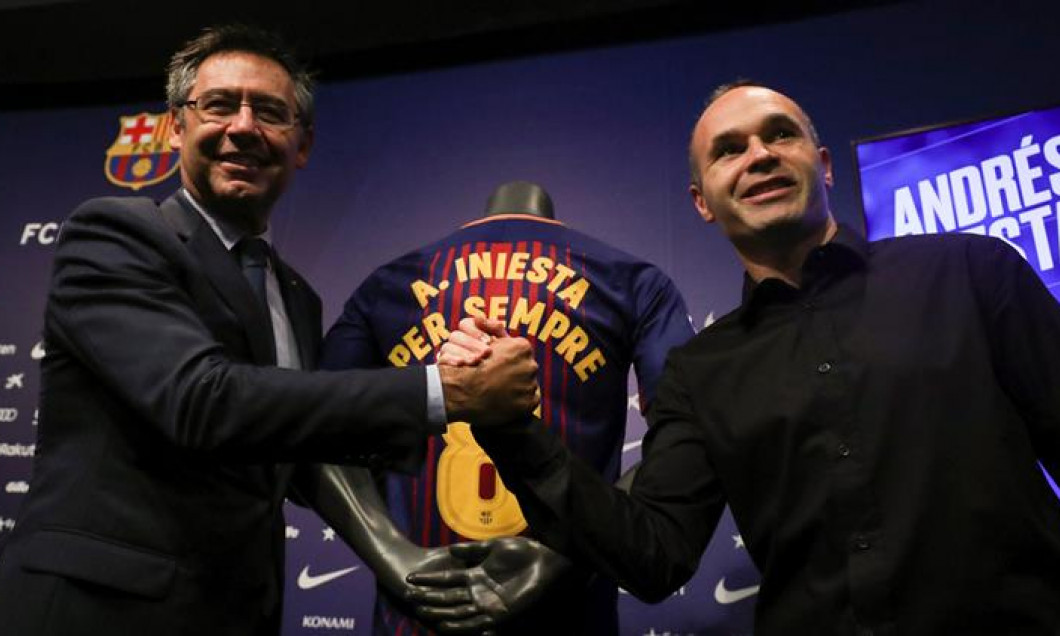 FC Barcelona captain Andres Iniesta shakes hands with FC Barcelona's President Josep Maria Bartomeu after announcing the agreement of a contract for life with FC Barcelona, in Barcelona