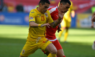 Nicolae Stanciu într-un duel pentru balon, în meciul cu Serbia
