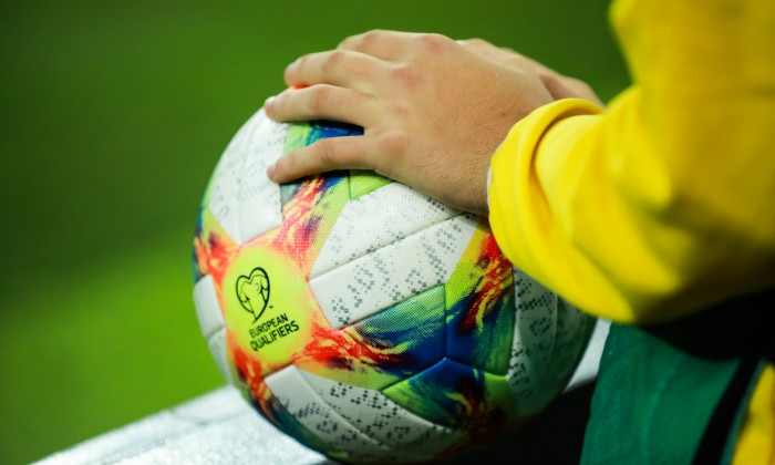 Bucharest, Romania - October 15, 2019: Details with the hands of a boy on an Adidas Conext 19 European qualifiers official soccer match ball on Arena