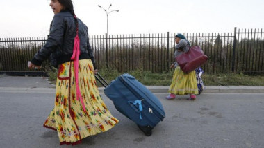 554385-borcha-sonita-a-16-year-old-roma-teenager-drags-her-suitcase-as-she-leaves-an-illegal-camp-in-croix