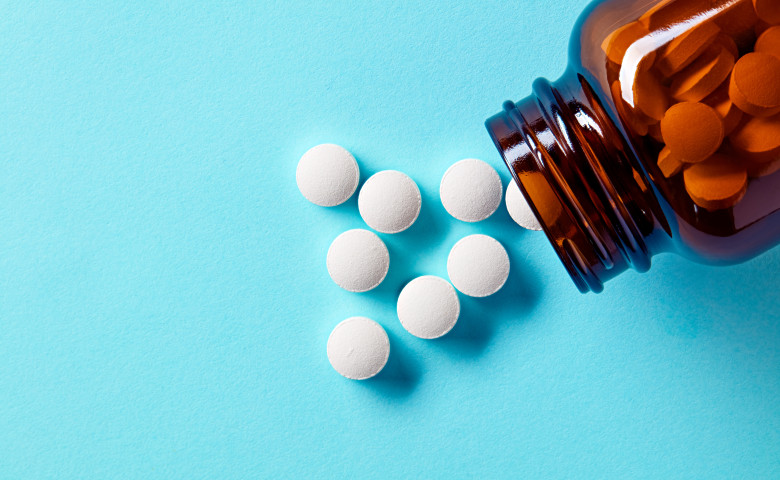 White,Medical,Pills,And,Tablets,Spilling,Out,Of,A,Drug