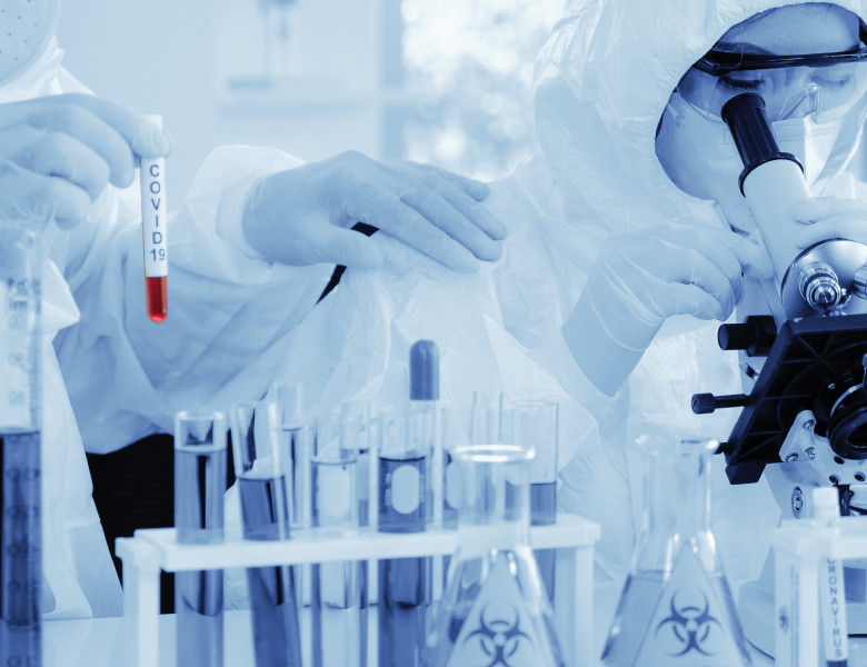 Scientist,In,Biohazard,Protection,Clothing,Analyzing,Covid,19,Sample,With