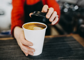 Barista,In,Apron,Is,Holding,In,Hands,Hot,Cappuccino,In