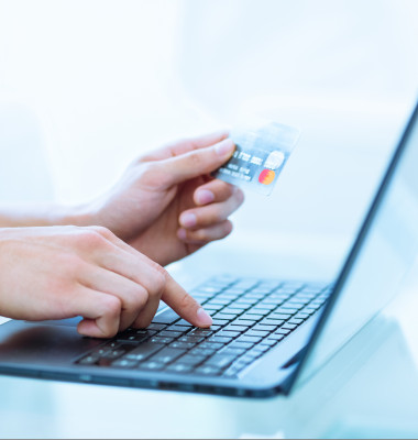 Close-up,Of,Hands,Shopping/paying,Online,Using,Laptop,And,Credit,Card.