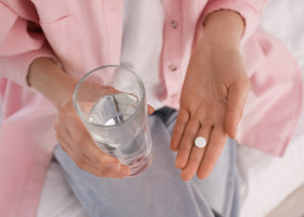 Young,Woman,With,Abortion,Pill,And,Glass,Of,Water,On