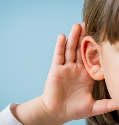 Child,With,Hearing,Problem,On,Blue,Background.,Hearing,Loss,In
