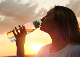 Young,Woman,Drinking,Water,To,Prevent,Heat,Stroke,Outdoors,At