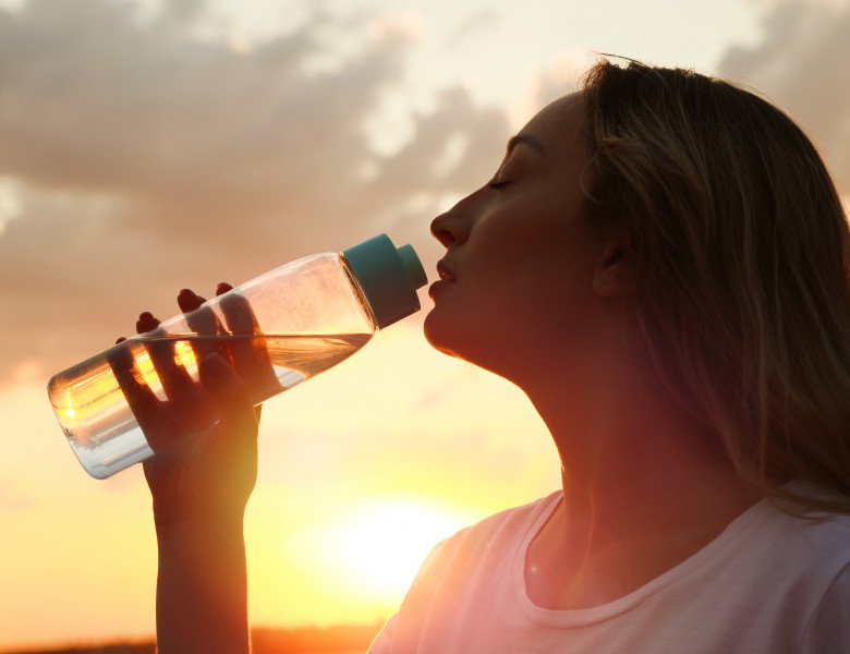 Young,Woman,Drinking,Water,To,Prevent,Heat,Stroke,Outdoors,At