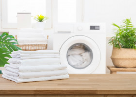 Stack,Of,Clean,Folded,Laundry,Bedding,Sheets,On,Wooden,Table