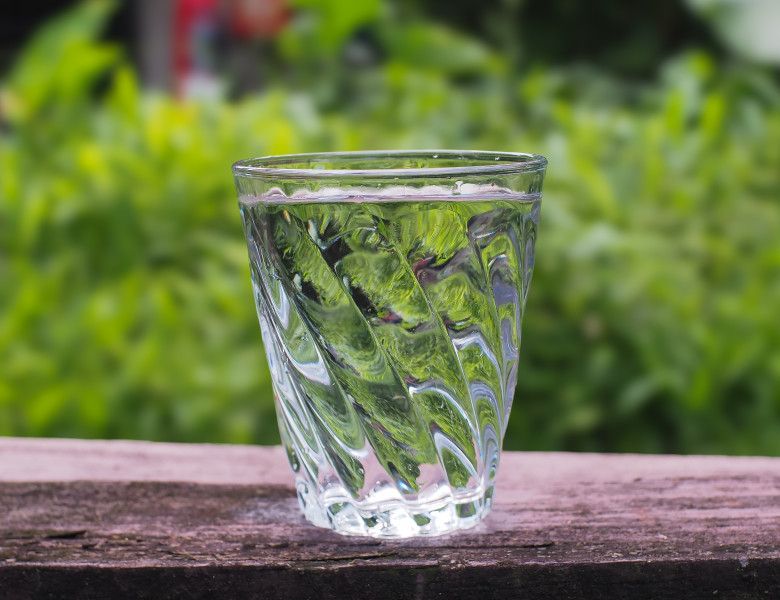 Fresh,Glass,Of,Drinking,Water,On,Wooden,Table,On,Blurred