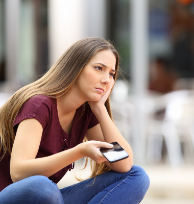 Sad,Girl,Waiting,For,A,Mobile,Phone,Call,Or,Message