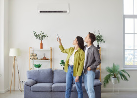 Family,Couple,Turning,On,The,Wall,Mounted,Air,Conditioner,At