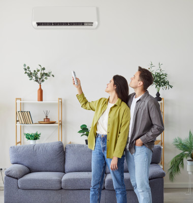 Family,Couple,Turning,On,The,Wall,Mounted,Air,Conditioner,At