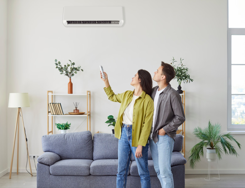 Family,Couple,Turning,On,The,Wall,Mounted,Air,Conditioner,At